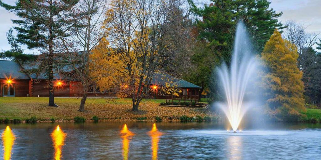 Floating fountain with a building visible in the background. 