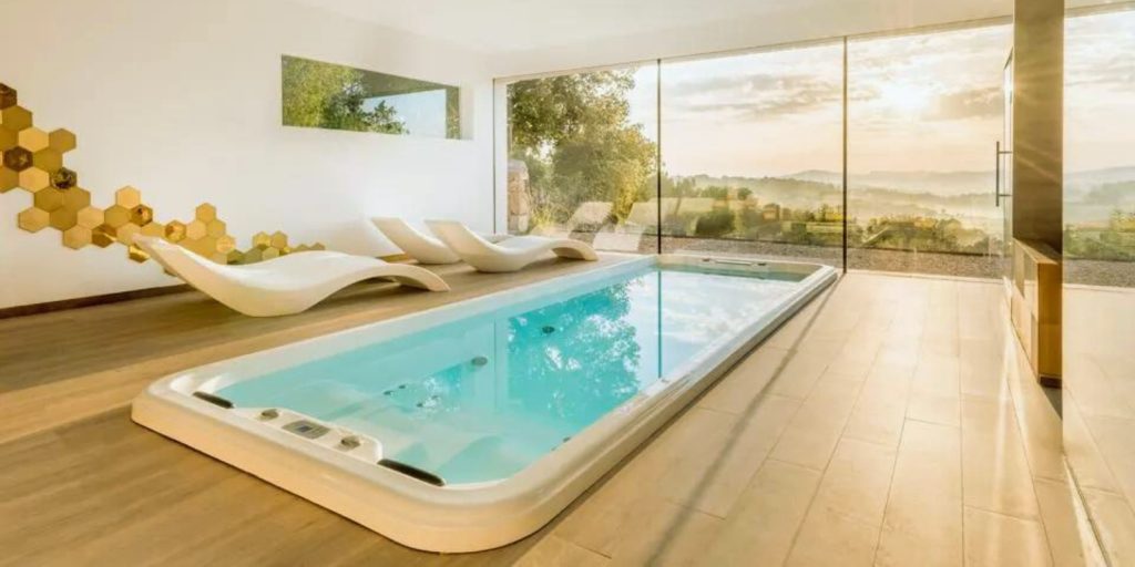 The pool is surrounded by a well-designed interior with a floor, walls, and a window.