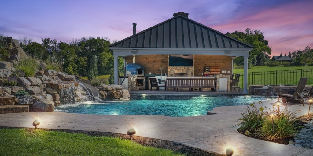 A swimming pool located in front of a house, with a clear view of the outdoor area.