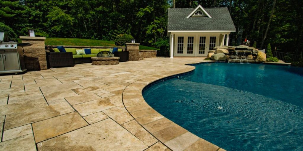 A swimming pool with a house in the background