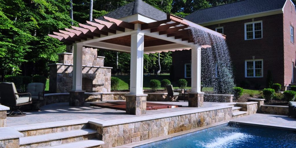 A poolside pergola in a backyard