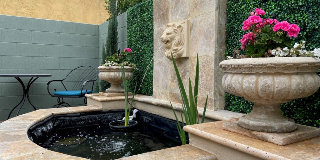 A fountain adorned with flowers and a statue.