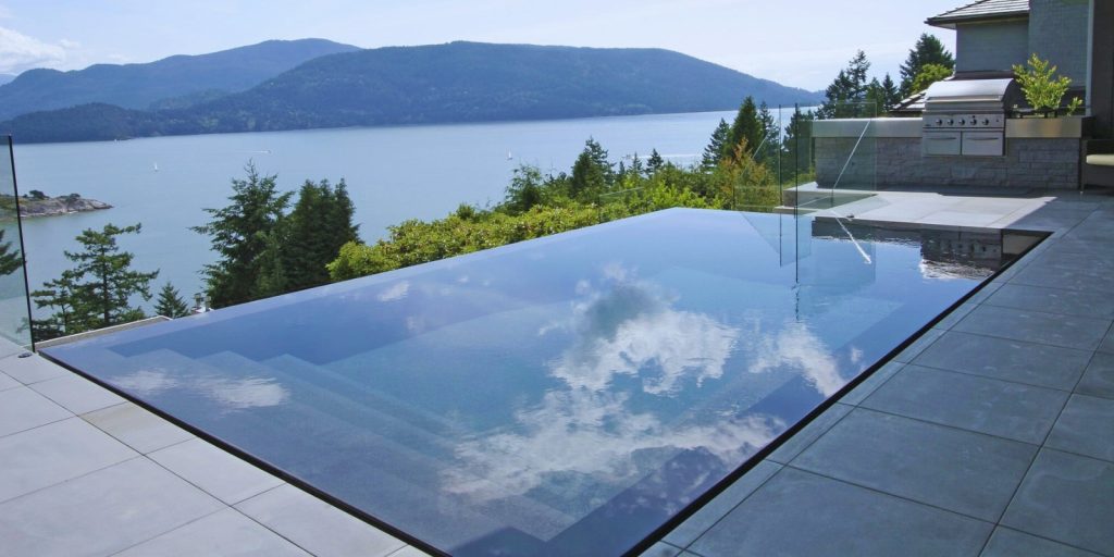 A Reflecting pool of water with trees and mountains