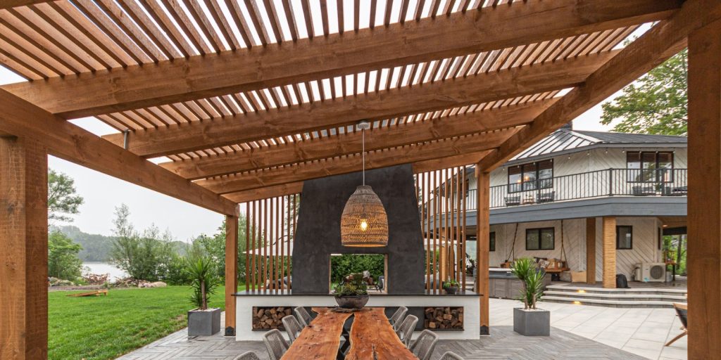 A building with a large patio, surrounded by plants and trees