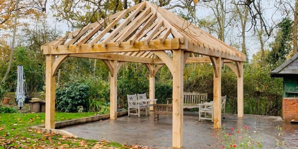 A wooden gazebo situated in a yard